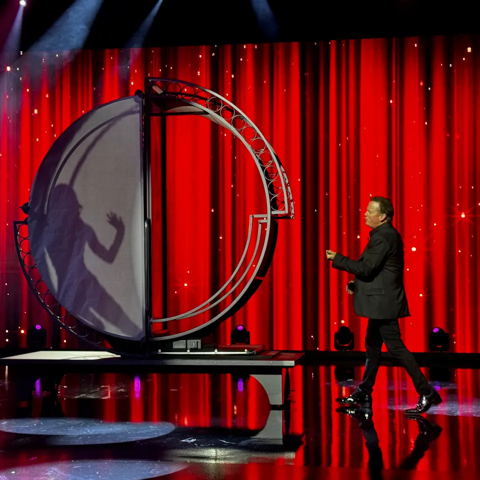 a person standing in front of a curtain